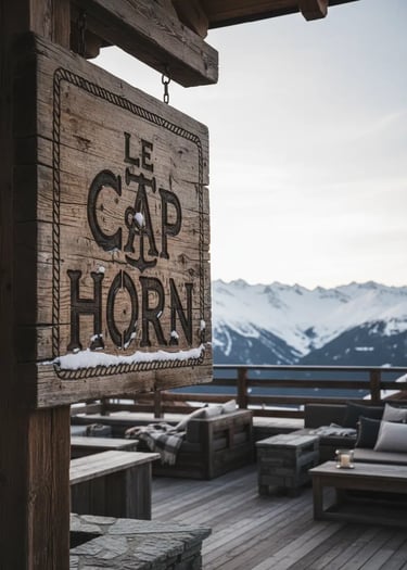 A rustic wooden sign for Le Cap Horn restaurant with snow-capped mountain peaks of Courchevel in the