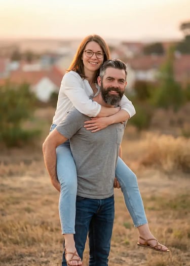 Couple doing piggyback pose in Mikulov vineyards at golden hour with town backdrop