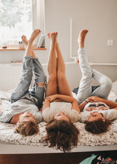 a couple of people laying on a bed