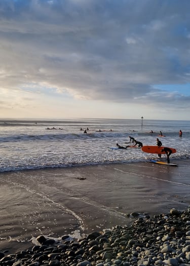 A busy surf lesson at Ynyslas with clean good waves and evening sunshine