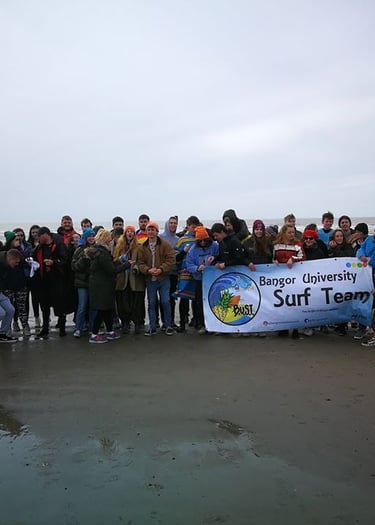 Aberystwyth and Bangor University surf clubs posing for a picture
