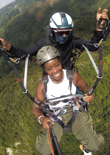 a man and woman are parasailing in the air