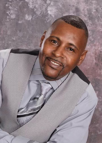 a man in a suit and tie smiling
