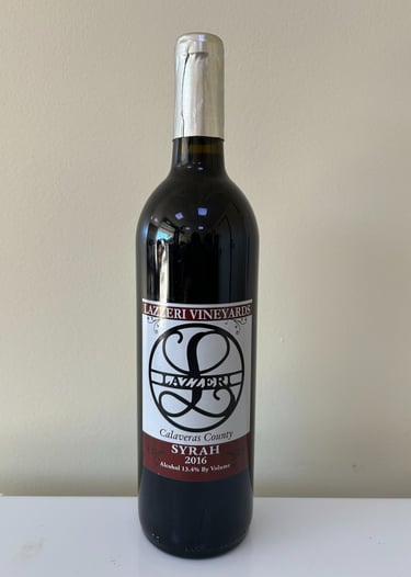 An unopened bottle of wine labeled Syrah