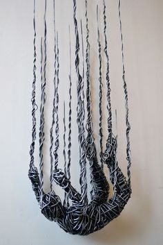 a black and white hanging bag of yarn yarn
