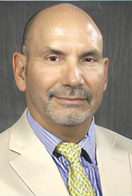 a man in a suit and tie with a yellow tie