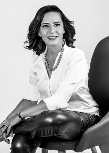 a corporate woman in a white shirt and leather pants