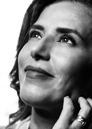 a womanlooking into the distance with a ring on her finger