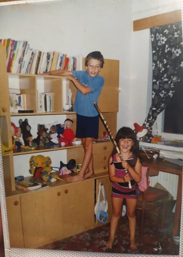 A young girl playing with a young boy