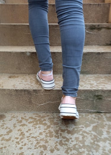 a person walking up some stairs with their feet on the ground