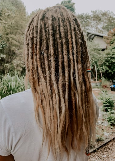 a woman with long hair and dreadlocks on her head