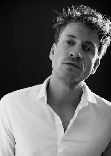 A black and white portrait of a young self-assured man.