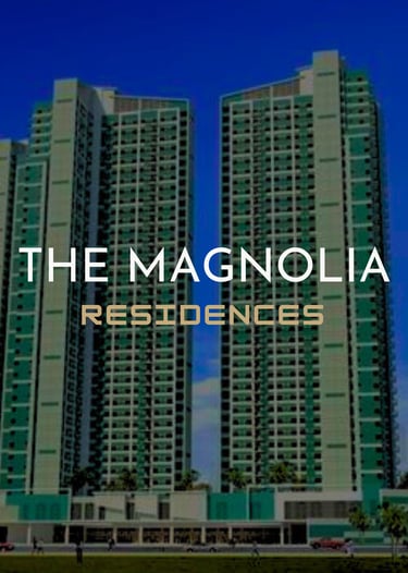 The Magnolia Residences luxury high-rise condominium towers standing against a clear blue sky.
