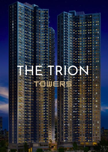 Modern high-rise architecture of The Trion Towers luxury condominiums in BGC at night.