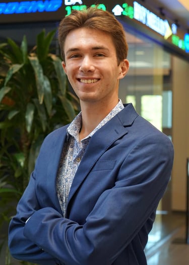 A headshot of Luke Gilmore in a suit.