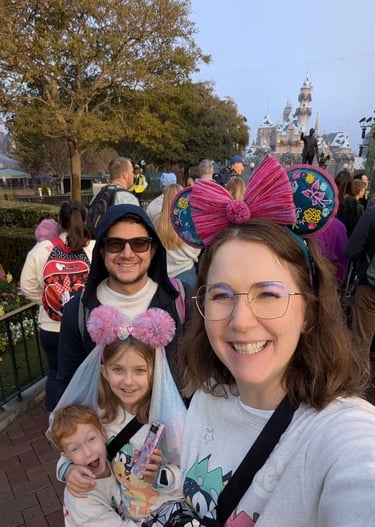 Katie Matzenbacher, Travel Agent, and her family in front of Sleeping Beauty Castle in Disneyland
