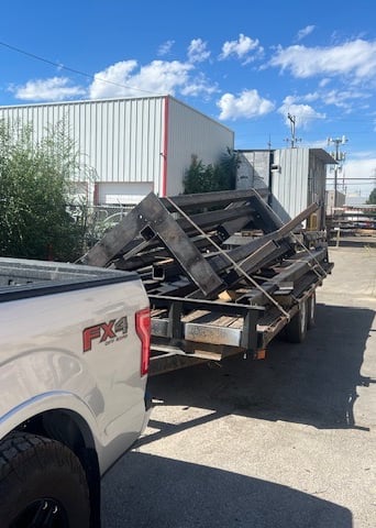 a truck with a trailer trailer loaded with a load of wood