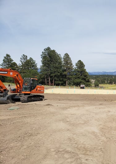 a tractor with a tractor loader in the background