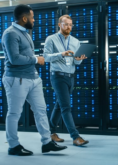 Two people walking in data center dressed in work attire