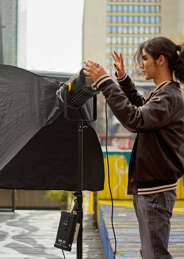 Youth setting up a video light