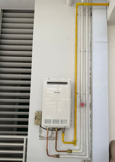 a tankless water heater with a yellow hose and a yellow hose