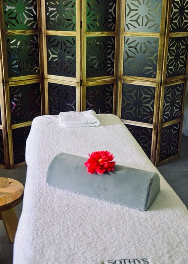 a massage room with a flower on the table