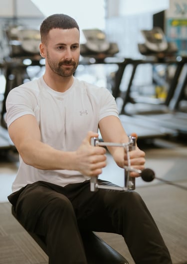Person performing weighted row in Leamington Spa gym, focused on strength and back activation