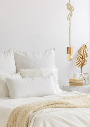 a bed with a white bed and a lamp