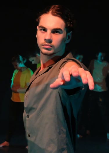 a man in a suit and tie is pointing at the camera