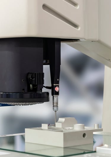Micro-Vu optical CMM performing a CMM touch probe on a machined part.