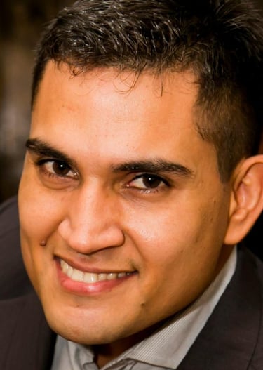 a man in a suit and tie is pointing at the camera