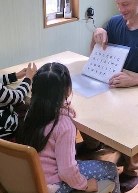 man teaching kids abcs