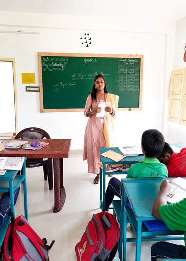 Teacher conducting an interactive classroom session with primary school students at Little Cubs Lear