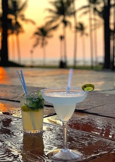 two cocktails with a view of the ocean