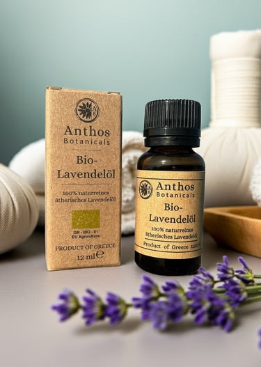 a bottle of lavender essential oil and lavender flowers