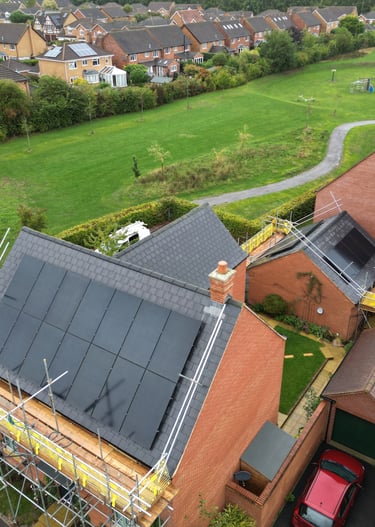 Aerial view of solar panel installation on a residential brick house in Brackley.
