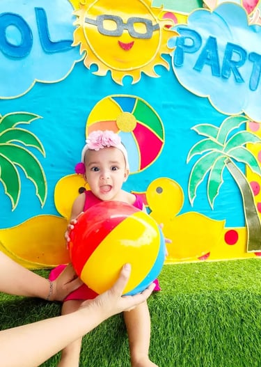 oddler enjoying water play activities to promote physical wellbeing and confidence at preschool.