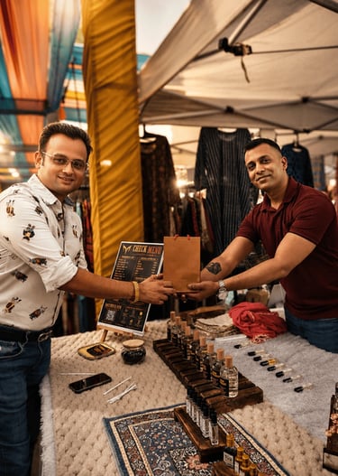 A smiling couple shopping at a vibrant night market with stalls and warm lighting.