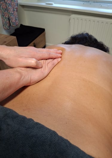 Stevige maar zachte druk op de schouderbladen en rug tijdens een ontspanningsmassage