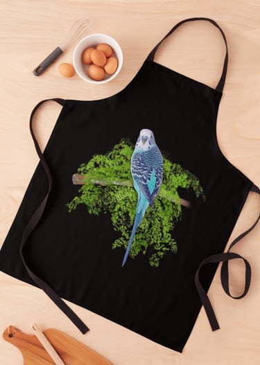 a blue parakeet bird sitting on a tree branch design on a black apron