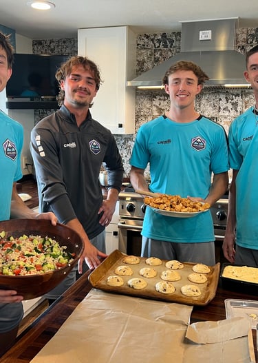 Midlakes soccer players showing off the meal with cookies they have prepared for The Sophia Way.