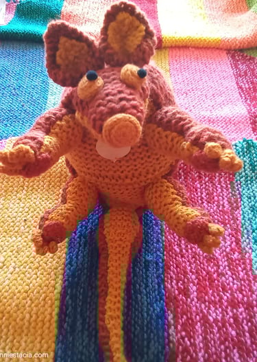 Small seated light brown armadillo