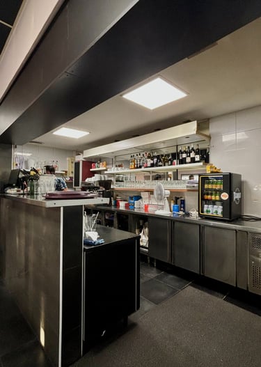 a kitchen with a large counter top and a refrigerator