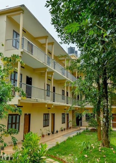 Beautiful exterior of Gooseberry Family Retreats in Wayanad, featuring well-maintained gardens and l