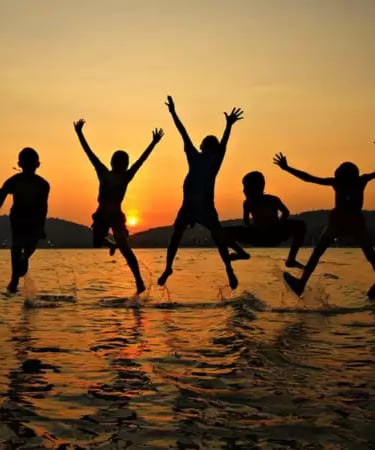 a group of people jumping in the air green Way Association