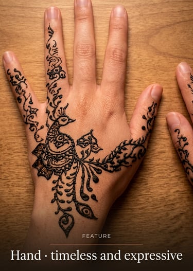 Intricate peacock henna tattoo design on a person's hand resting on a wooden table.