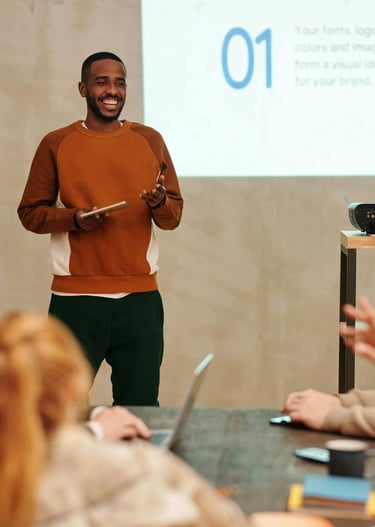 a man standing in front of a presentation on a projector