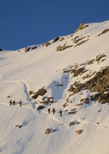 a group of people walking up a snowy mountain - Huayna Potosi in Bolivia
