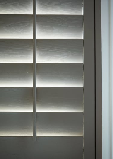 White wooden plantation shutters with hidden tilt rod