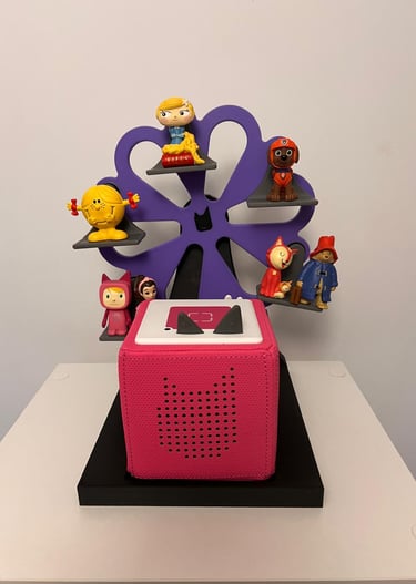 Pink Toniebox audio player with Tonies figures on a purple ferris wheel shelf.